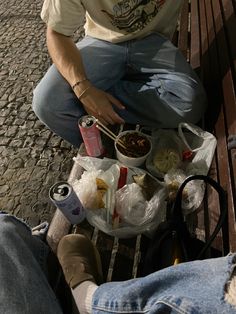 a man sitting on a bench eating food