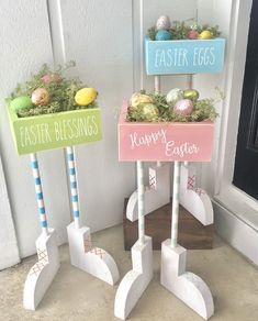 easter decorations made out of wooden sticks and painted eggs