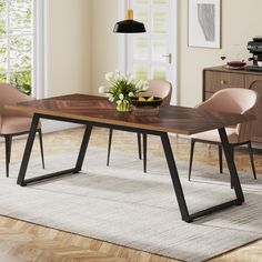 a dining table with two chairs and a potted plant on the side in front of it