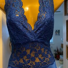 a mannequin with blue lace on it in front of a yellow display case