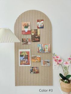 a white wall with pictures and flowers on it