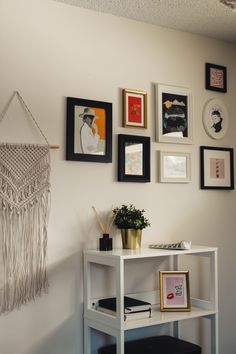 a white table with some pictures on the wall