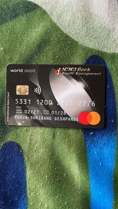 a credit card sitting on top of a colorful cloth