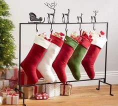 christmas stockings hanging on a rack with presents