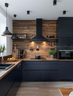 a kitchen with wooden walls and black cabinets is pictured in this image, there are lights hanging from the ceiling