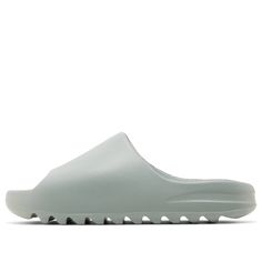 The adidas Yeezy Slide 'Salt' epitomizes minimalist design and comfort. This sandal features the brand’s signature aesthetic. Its allover grey color scheme exudes understated elegance. Constructed from lightweight injected EVA foam, the slide boasts an open-toe design for ventilation. The deep horizontal grooves on the outsole provide a grippy textured traction pattern. Salt Yeezy Slides Outfit, Grey Yeezy, Yeezy Slides Outfit, Yeezy Slides, Slides Outfit, Grey Color Scheme, Eva Foam, Grey Outfit, Adidas Yeezy