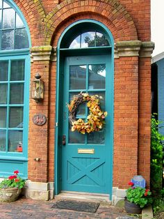 a blue front door with a wreath on it