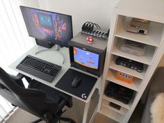 a computer desk with two monitors and a keyboard