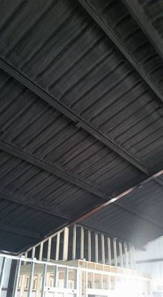 the inside of an empty building with metal bars on it's sides and windows