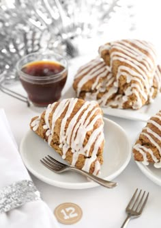 three white plates topped with cookies covered in frosting