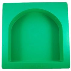 a green plastic tray with an arch on the top and bottom, set against a white background