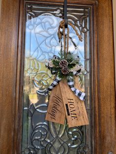 the front door is decorated with burlocks and pine cones