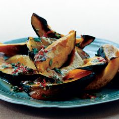 a blue plate topped with squash covered in sauce