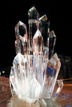 a crystal sculpture sitting on top of a pile of rocks