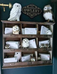 stuffed owls sitting on top of an old wooden shelf filled with mail and envelopes