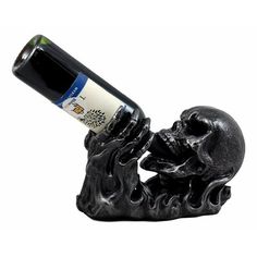 a bottle holder with a skull holding a wine bottle in it's mouth,