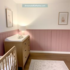 a baby's room with pink walls and white crib