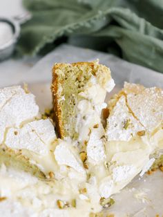 a piece of cake with powdered sugar and icing sitting on top of it