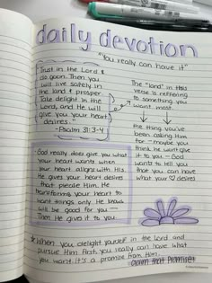 an open book with writing on it and two markers next to it that says daily devotion