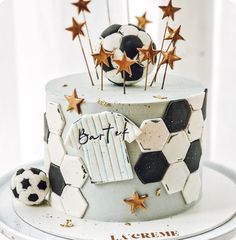 a birthday cake with soccer balls and stars on it