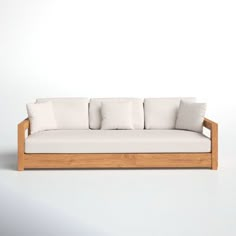 a white couch sitting on top of a wooden frame