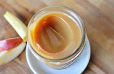 an apple cider sitting on top of a white plate