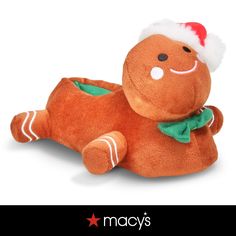 an orange stuffed animal with a santa hat and green bow on it's head