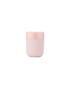 a pink cup sitting on top of a white table