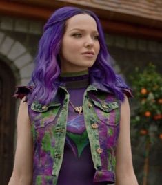 a woman with purple hair wearing a green vest