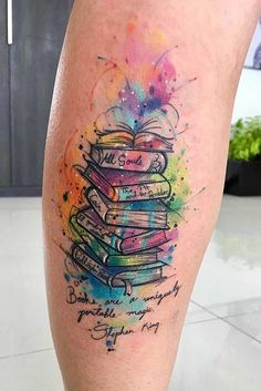 a person with a tattoo on their leg that has books stacked on top of each other