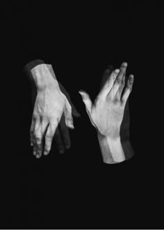 two hands reaching towards each other in the dark