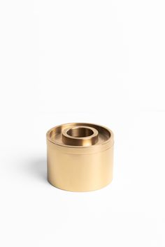 an empty brass container on a white background