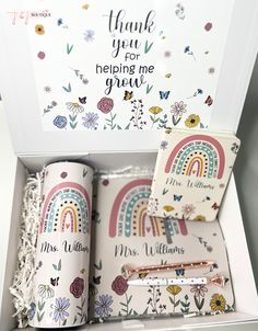 a white box filled with lots of different items next to a thank you card and pen