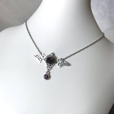 This gothic vampire inspired necklace is made with an antiqued silver plated filigree bat and findings, accented with sparkling glass crystals in DEEP VIOLET PURPLE. Wingspan is 2 1/4" wide and centerpiece is 1 1/2" tall in the center.necklace isadjustable 15-18" with a lobster clasp and chain extender in the back. If you would like a different length or stone color, please send us a message. Matching headpiece is available in our store. Goth Jewelry Violet Vixen, Silver Vampire Style Necklace, Gothic Nickel-free Necklace For Halloween, Gothic Nickel-free Necklaces For Halloween, Gothic Pendant Necklace For Halloween, Halloween Gothic Pendant Necklace, Gothic Metal Jewelry For Fantasy Events, Halloween Gothic Pendant Jewelry, Silver Gothic Necklaces For Fantasy Events