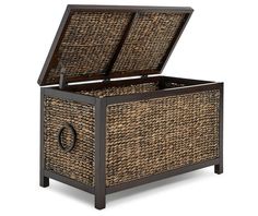 an open wicker chest with lid and handles