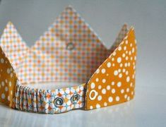 an orange and white polka dot paper crown