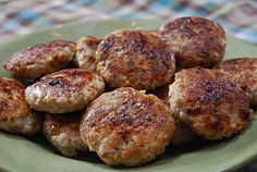 some meat patties are on a green plate