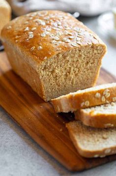 a loaf of bread sitting on top of a wooden cutting board