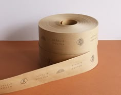 two rolls of brown paper sitting next to each other