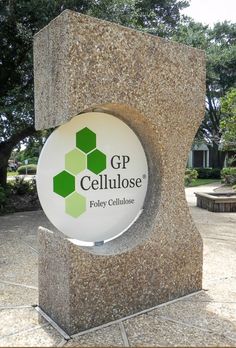 a sign for the cellulose facility in front of a stone sculpture with hexagonal shapes