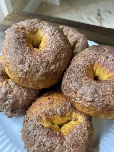 four donuts sitting on top of a white plate