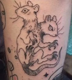 a tattoo on the leg of a person with a rat and mouse in front of it