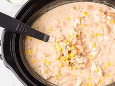 a crock pot filled with chicken and corn soup