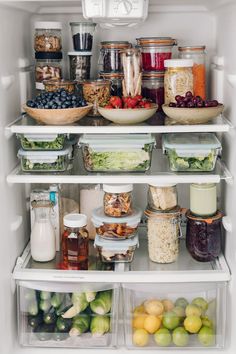 a refrigerator filled with lots of food and condiments on it's shelves