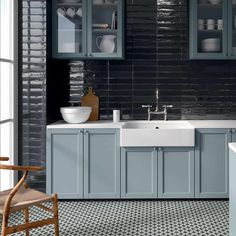 a kitchen with blue cabinets and white sink