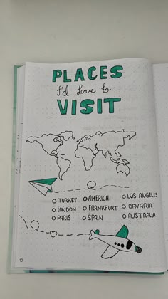 an open notebook with the words places to visit written in green and black on it