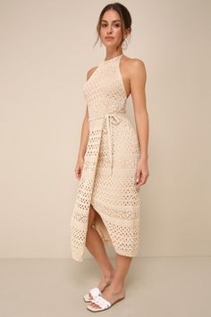 Slip into the Lulus Blissful Strolls Beige Crochet Faux-Wrap Halter Midi Dress and take a leisurely walk through the palms! This vacay-ready crochet-knit dress has a tying halter neckline and a fitted bodice with a flirty open-back design. The high waist sits atop a column skirt that boasts an overlapping panel that ties at the hip to create a wrap effect, all before ending at a modern midi hem. Fit: This garment fits true to size. Length: Mid-calf length. Size medium measures 45" from top to bo Halter Top Dress, Wrap Dress Midi, Crochet Knit Dress, Beige Crochet, Column Skirt, Halter Top Dresses, The Palms, Halter Midi Dress, Faux Wrap Dress