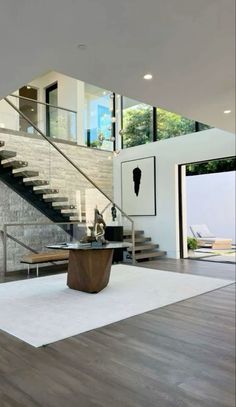 a modern living room with stairs leading up to the second floor