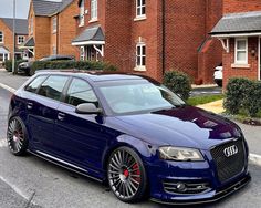 a blue car parked in front of some houses