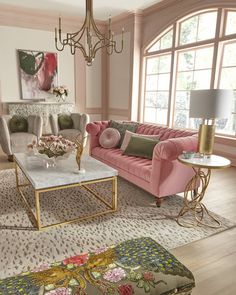 a living room filled with pink couches and chairs